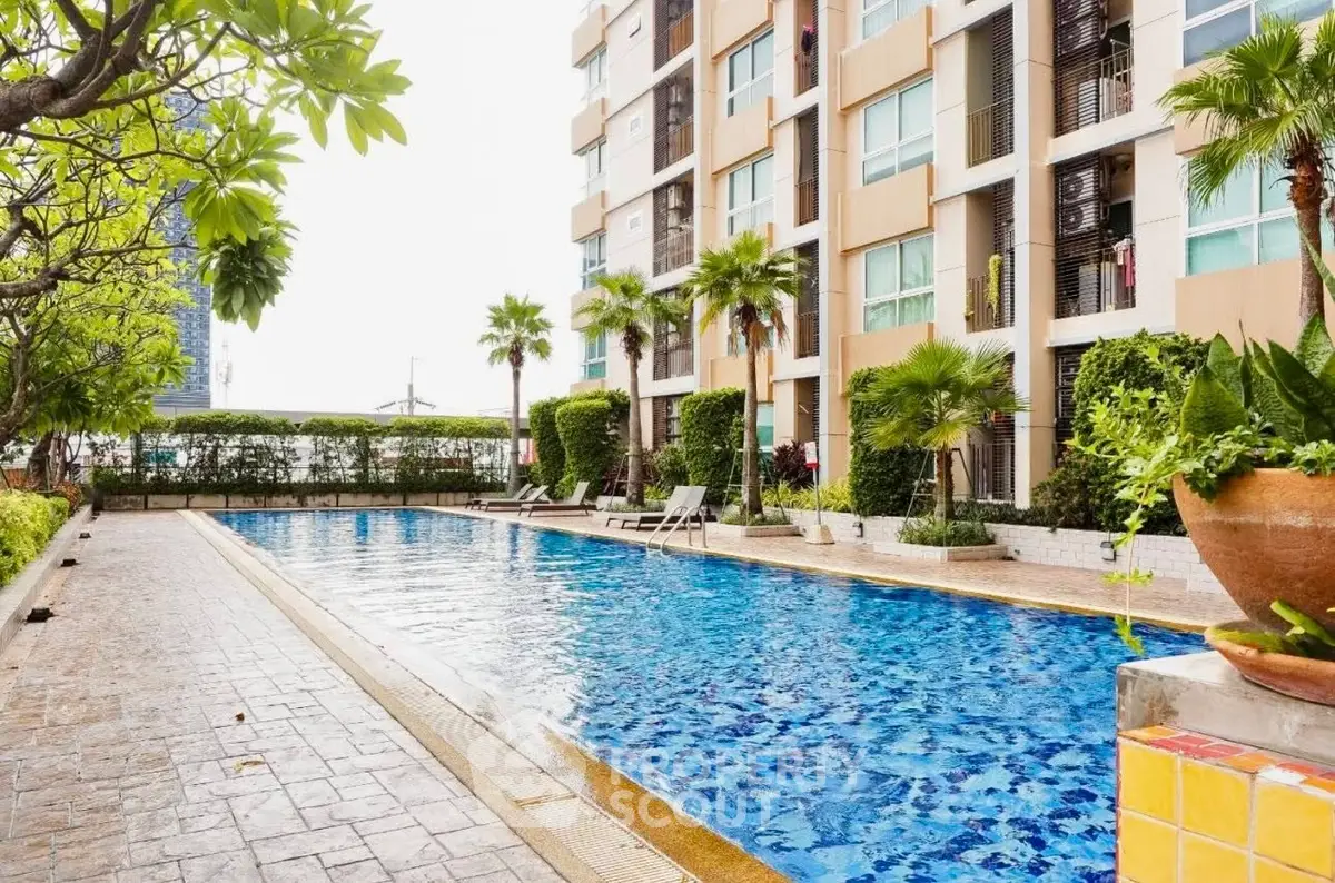 Luxurious apartment building with a stunning outdoor pool and lush greenery, perfect for relaxation and leisure.