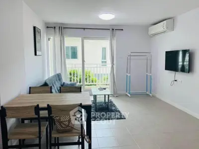 Modern living room with sleek furniture and wall-mounted TV in bright apartment