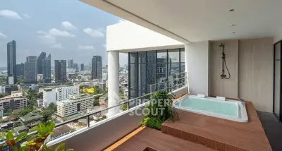 Luxurious balcony with jacuzzi and stunning city skyline view in modern high-rise apartment.