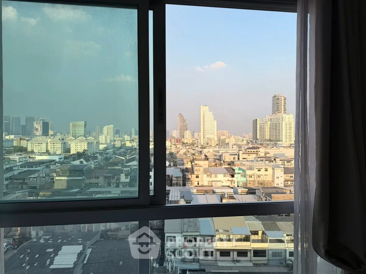 Stunning cityscape view from a high-rise apartment window, showcasing urban skyline and vibrant city life.
