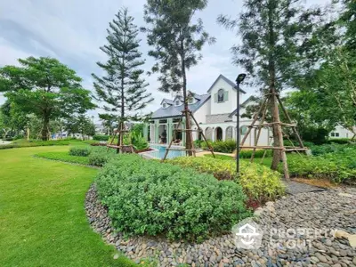 Charming house with lush garden and manicured lawn, perfect for serene living.