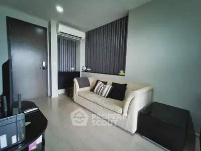 Modern living room with sleek design and comfortable sofa in stylish apartment.