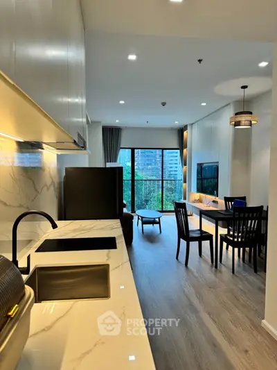Modern open-layout kitchen and living room with balcony view in luxury apartment
