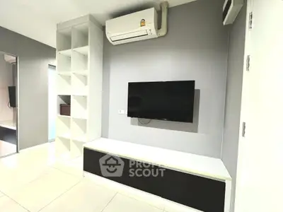 Modern living room with wall-mounted TV and air conditioning unit