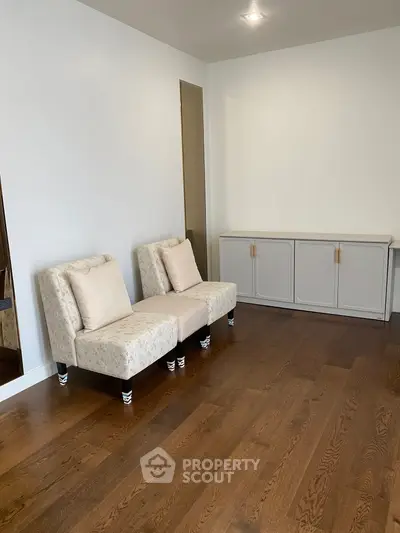 Elegant living room with hardwood floors and stylish seating