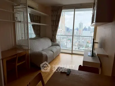 Cozy living room with city view and balcony access in modern apartment.