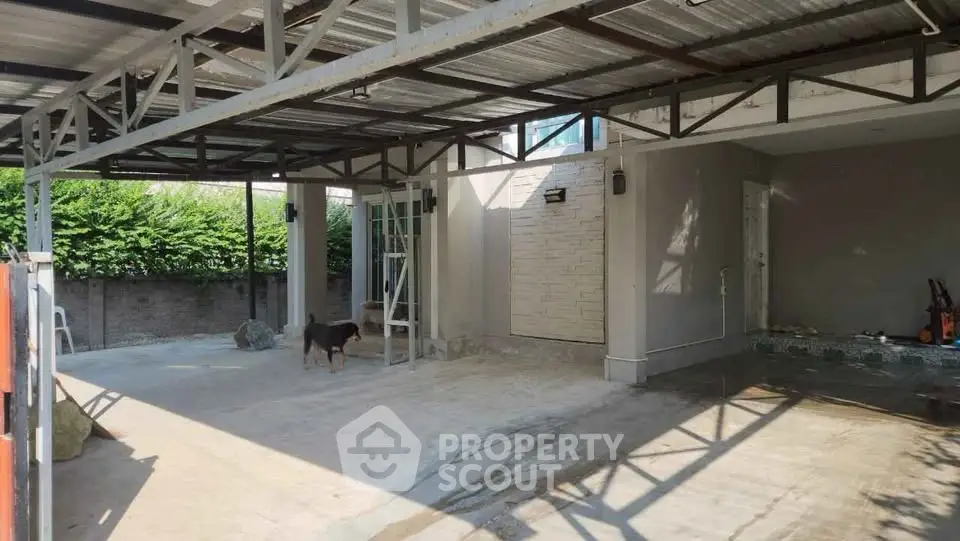 Spacious covered parking area with modern design and ample natural light.