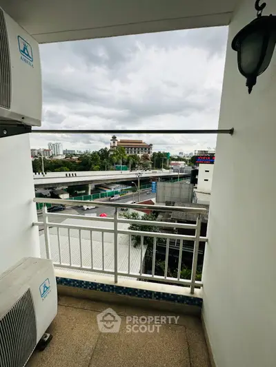 Charming balcony with city view, perfect for relaxing and enjoying the urban landscape.