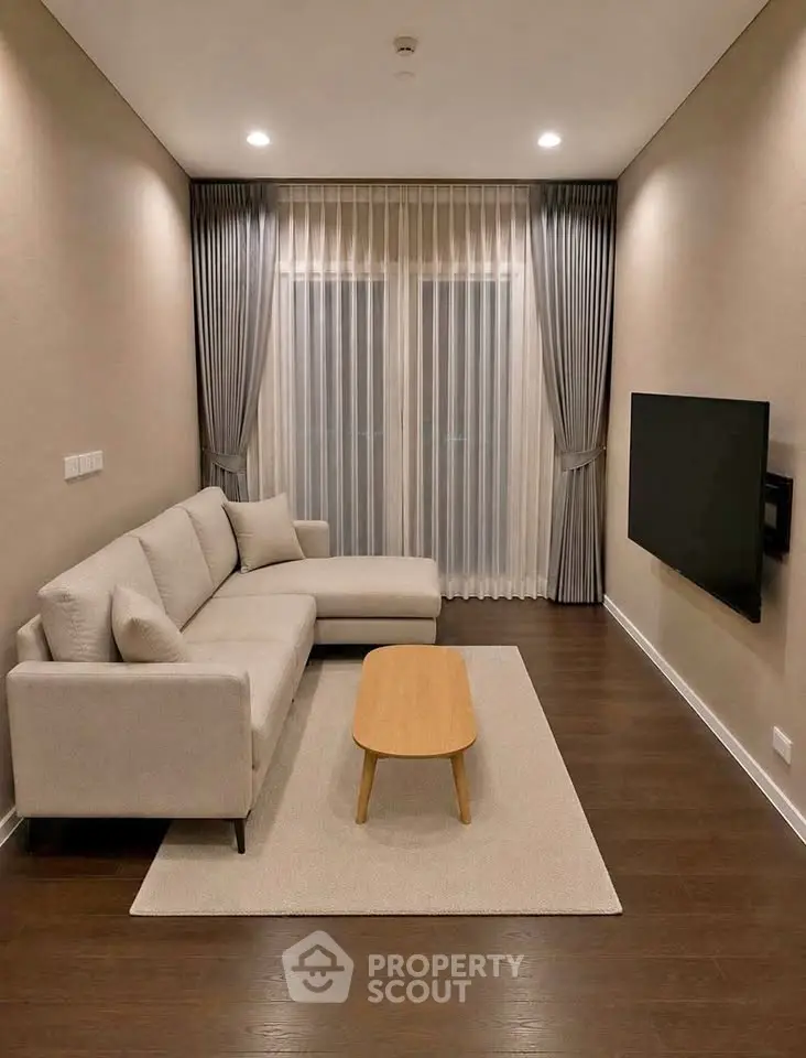 Modern living room with sleek design, featuring a cozy sofa, wall-mounted TV, and elegant curtains.
