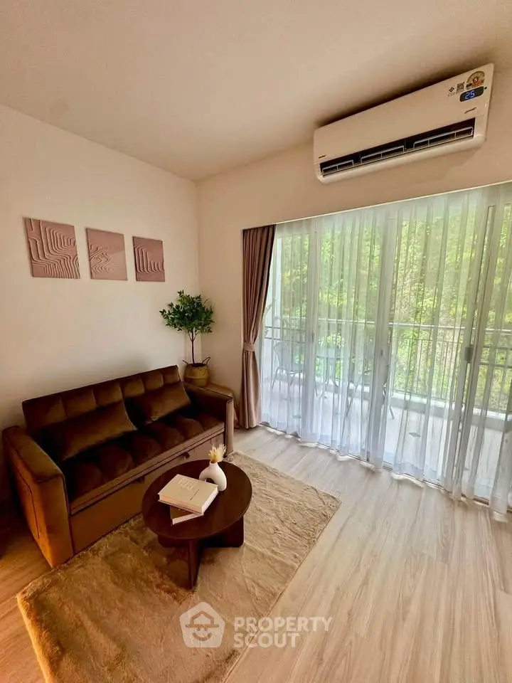 Charming living room with cozy sofa, stylish decor, and balcony view, perfect for relaxation and entertaining.