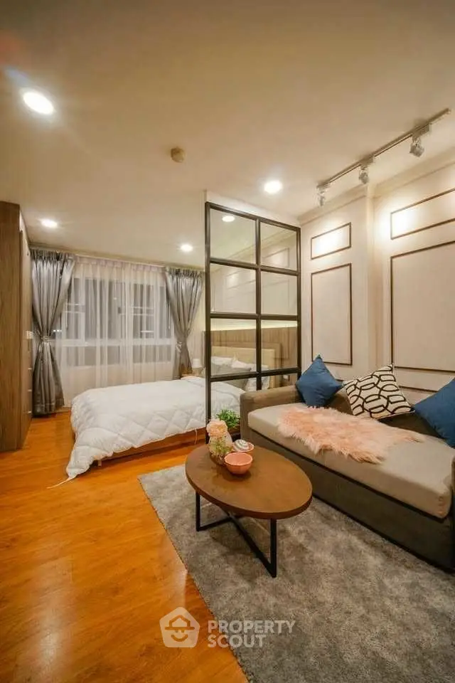 Modern studio apartment with cozy living area and stylish bedroom