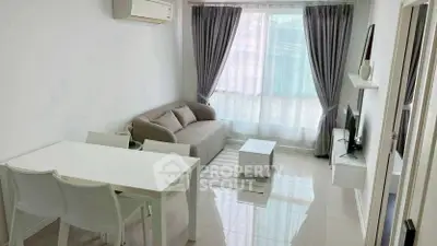 Modern living room with sleek furniture and large window, perfect for cozy gatherings.