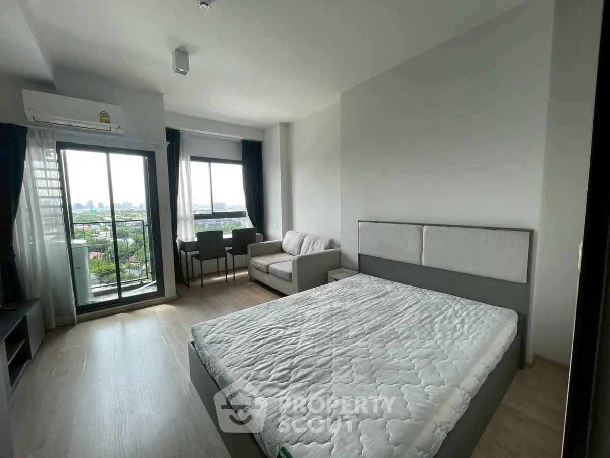 Modern bedroom with balcony view in a high-rise apartment