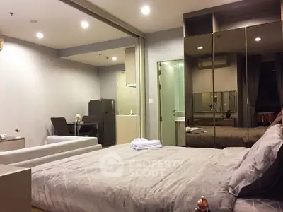 Modern bedroom with mirrored closet and cozy decor in a stylish apartment.
