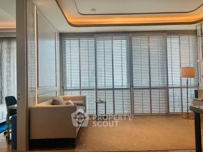 Luxurious living room with elegant decor and large windows offering abundant natural light.