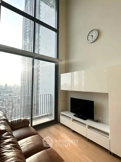 Modern living room with high ceilings and city view from large windows.