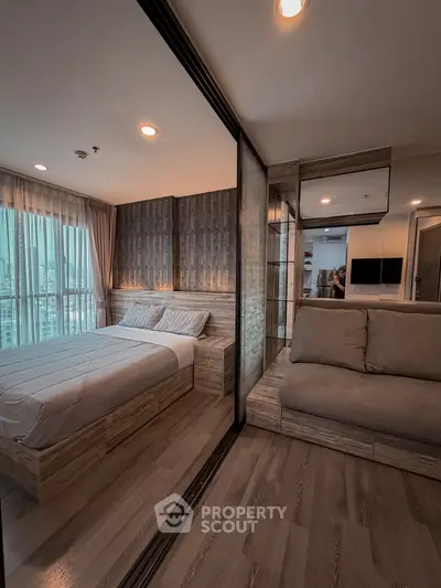 Modern bedroom with stylish decor and city view, featuring cozy bed and elegant lighting.