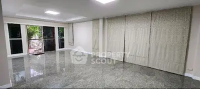 Spacious empty living room with large windows and garden view