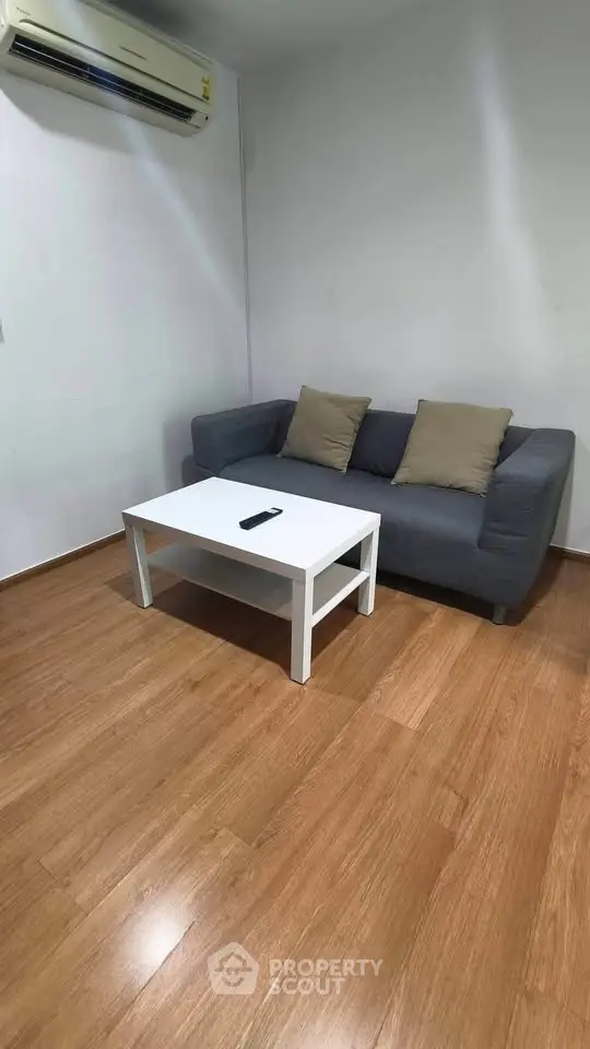 Cozy living room with modern sofa and sleek wooden flooring