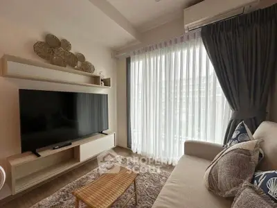 Cozy living room with modern decor and large TV, perfect for relaxation.