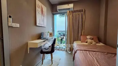 Cozy bedroom with balcony view, featuring a desk and air conditioning.