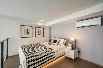 Modern bedroom with stylish decor and air conditioning in a contemporary apartment.