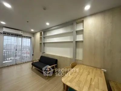 Modern living room with wooden flooring, built-in shelves, and a cozy sofa in a high-rise apartment.