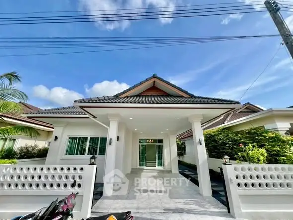 Charming single-story house with tiled roof and spacious driveway in a serene neighborhood.