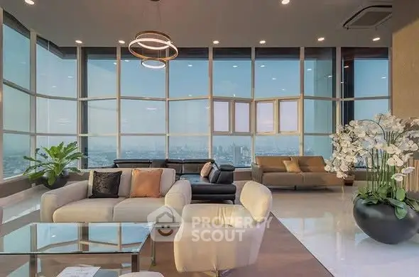 Luxurious penthouse living room with panoramic city views and elegant modern decor.