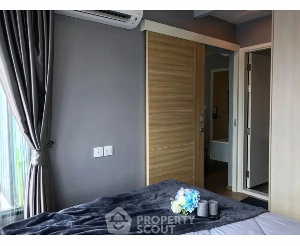 Modern bedroom with sleek design and soft lighting, featuring a cozy bed and stylish decor.