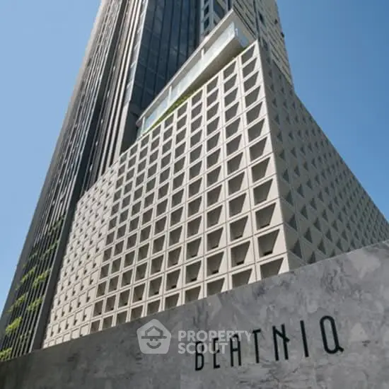 Stunning modern high-rise building exterior with unique architectural design in urban setting.