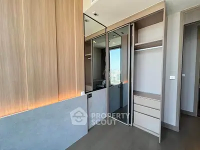 Modern bedroom with built-in wardrobe and sleek wooden paneling