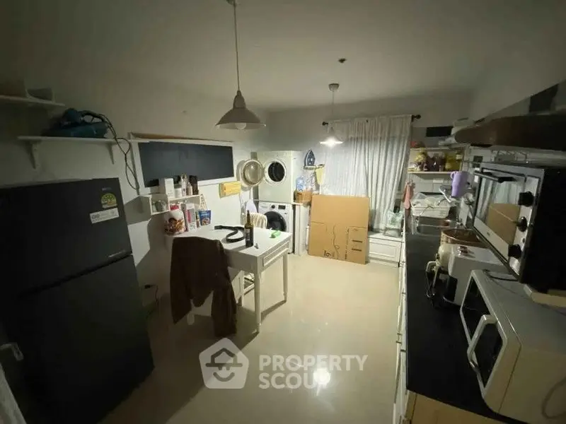 Cozy kitchen with modern appliances and ample storage space, perfect for culinary enthusiasts.