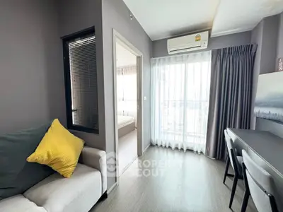 Modern apartment interior with cozy living room and bright balcony view.