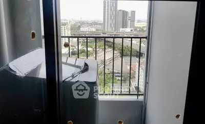 Compact balcony with washing machine and city view, ideal for urban living.