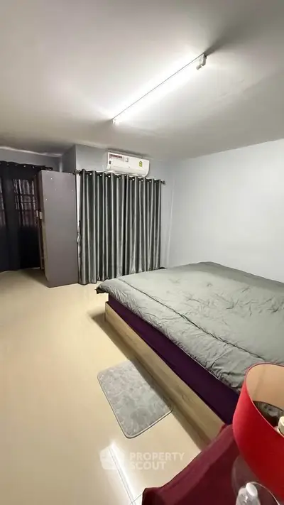 Spacious bedroom with modern decor and ample natural light