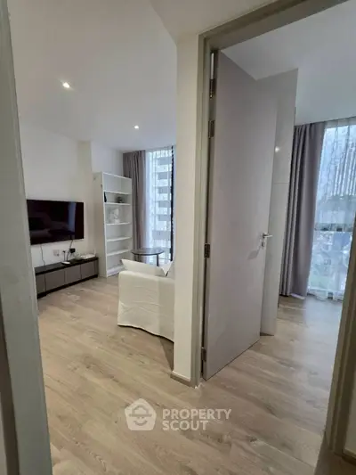 Modern living room with sleek TV setup and cozy seating area