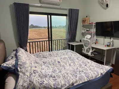 Cozy bedroom with scenic view and modern workspace setup