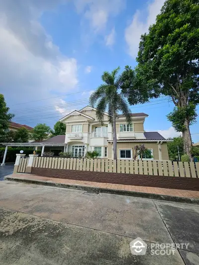 Charming two-story house with lush garden and modern design in serene neighborhood.