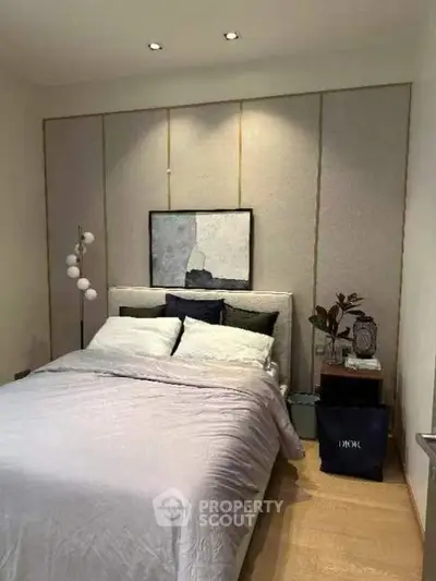 Elegant bedroom with modern decor and cozy bedding in a stylish apartment.