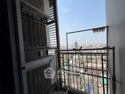 High-rise balcony with cityscape view and air conditioning units