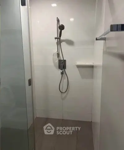 Modern bathroom shower with sleek design and glass door enclosure.