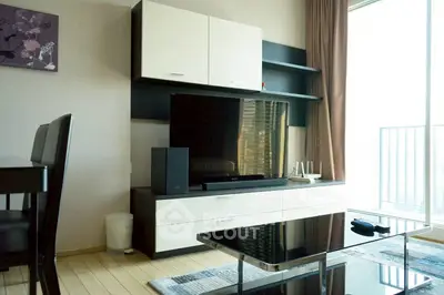 Modern living room with sleek entertainment center and large window view.