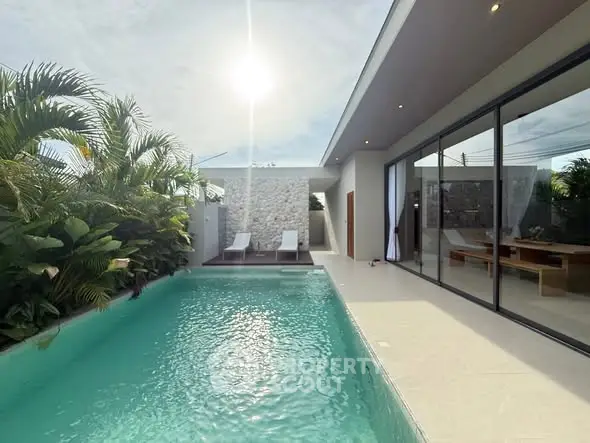 Luxurious modern villa with private pool and lush garden, perfect for relaxation and entertaining.