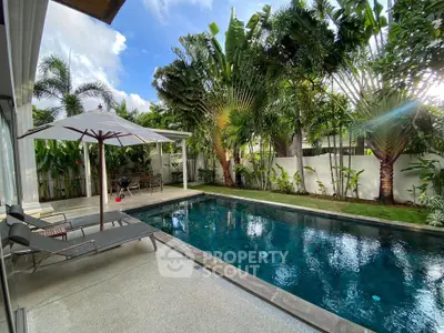 Luxurious tropical villa with private pool and lush garden, perfect for relaxation and entertaining.