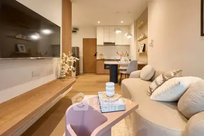 Modern living room with cozy seating and stylish decor in open layout apartment.
