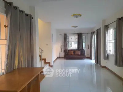 Spacious living room with modern decor and large windows for natural light.