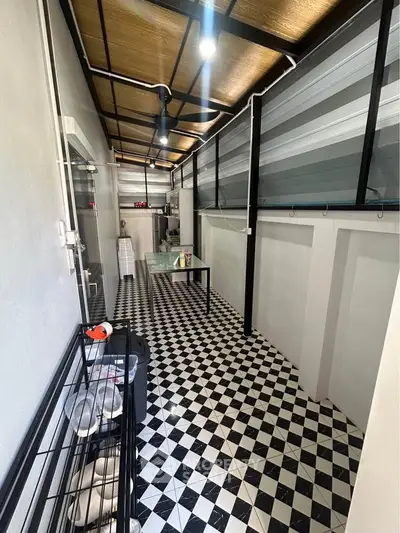 Chic enclosed balcony with checkered floor and modern decor