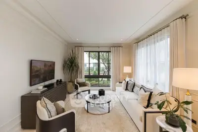 Elegant living room with large window and stylish furniture, perfect for modern living.