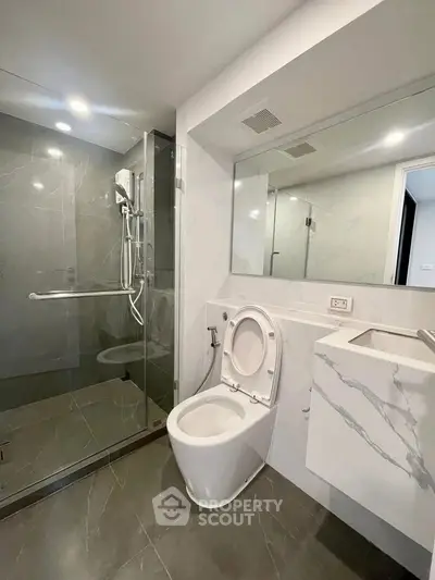 Modern bathroom with glass shower and sleek fixtures